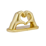 Buchstütze Herzhände